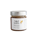 Colheita multi-floral honey in a glass jar with a silver lid and a label featuring a bee illustration.